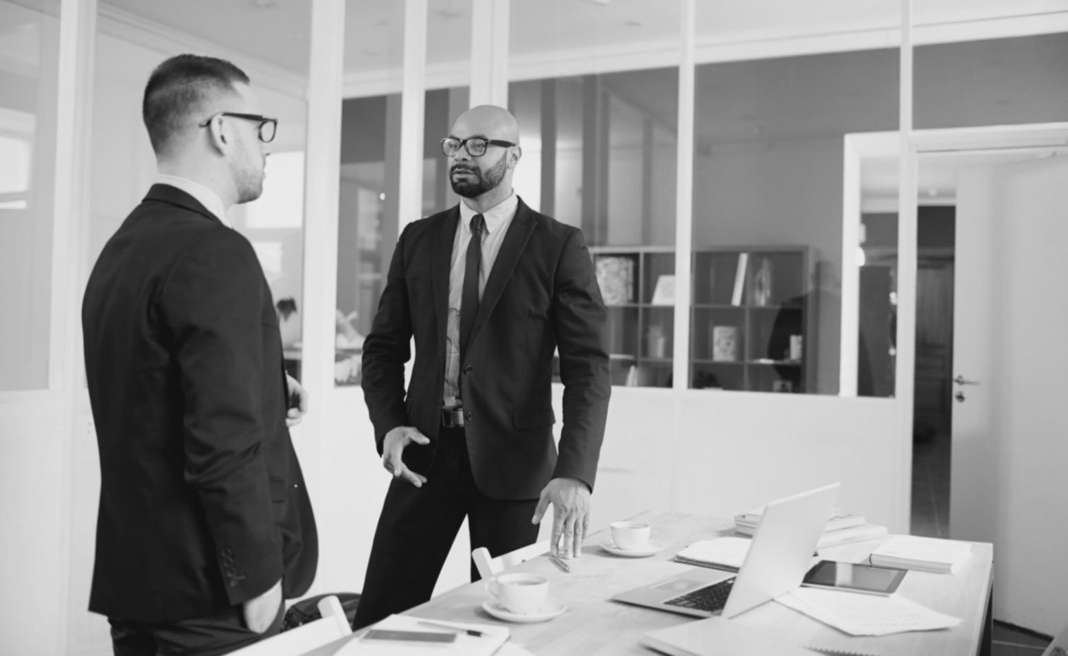 Collaborative workspace with investment professionals working together on financial analysis